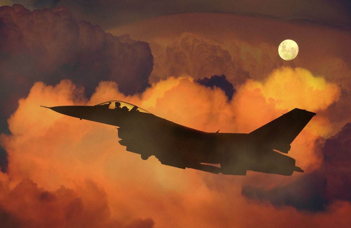 Military plane at sunset.
