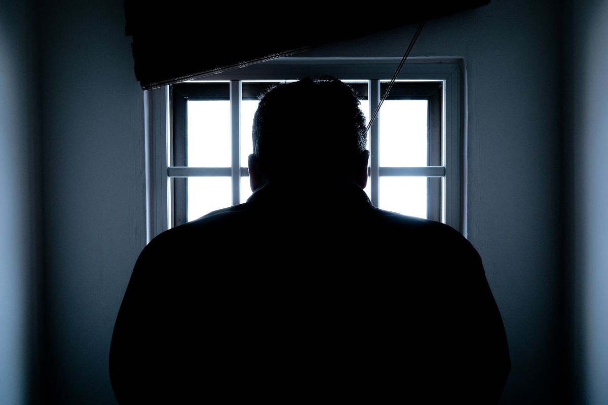 Silhouette of man in window.