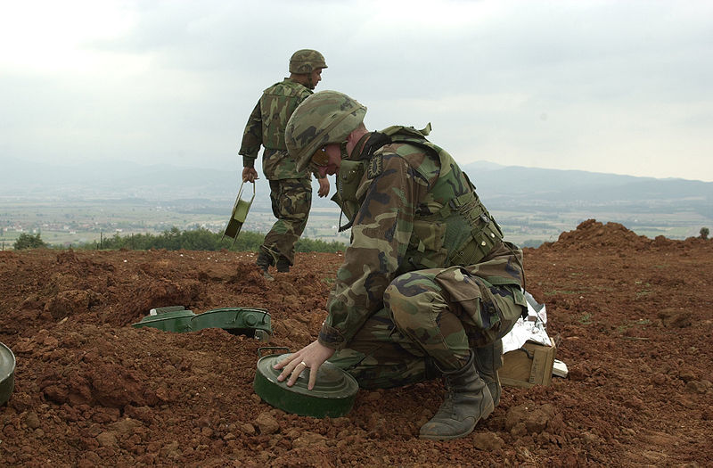 Soldiers laying down landmines.