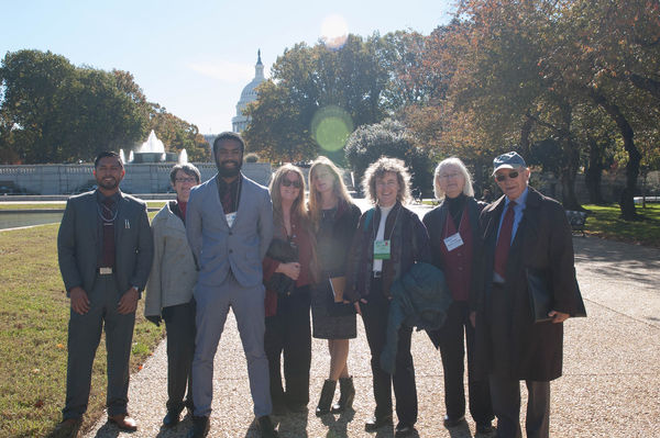 Group poses in front of the Capitol