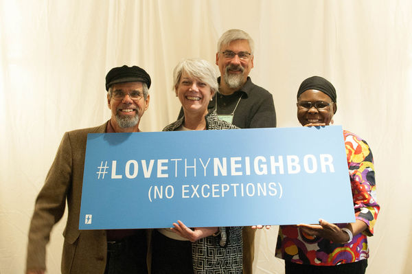 Group holds a love thy neighbor sign